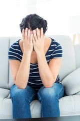 Unhappy woman sitting on the couch