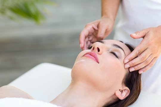 Brunette receiving head massage