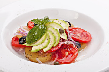 Close- up of vegetable salad on plate isolated on white