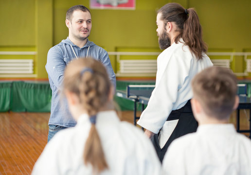 Kids father talking to aikido instructor