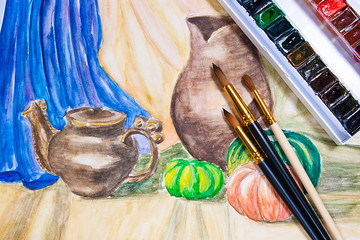 Paints with brushes on the watercolors painting.