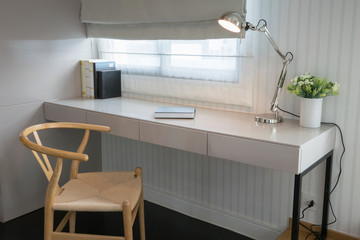 white table with wooden chair and books in modern working area a