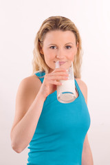 young athlete girl with glass of milk