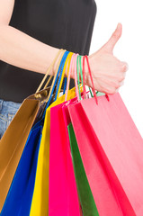 Shopping bags on woman arm and thumbs up