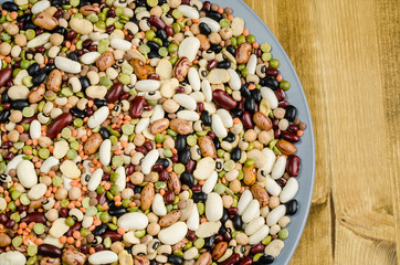 legumes in a dish on wood, close up, background