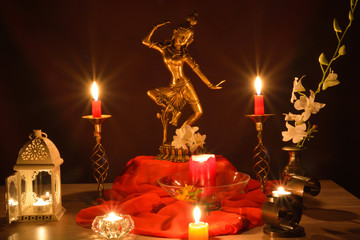 Tara, goddess statue of compassion and lit candles on altar, Buddhist Indian tradition - obrazy, fototapety, plakaty