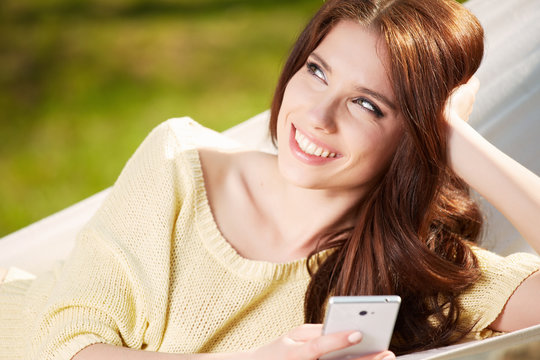Happy Young Woman relaxing in hammock