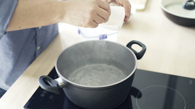 Man boiling water in pot slow motion shot at 240fps
