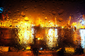 Night city through a wet window
