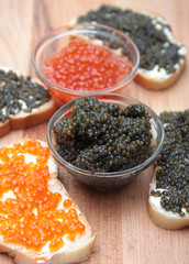 Black and red caviar in glass container