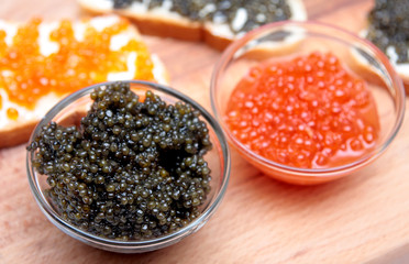 Black and red caviar in glass container