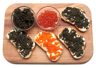 Black and red caviar in glass container