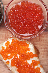 Black and red caviar in glass container
