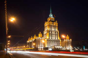 Obraz premium Illuminated Royal Hotel Radisson (Hotel Ukraina) near river at n