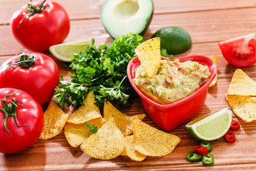 Guacamole with avocado, lime, tomato, and cilantro