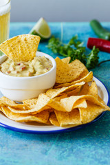 Guacamole with avocado, lime, tomato, and cilantro