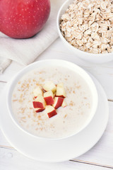 Oat porridge with red apple slices