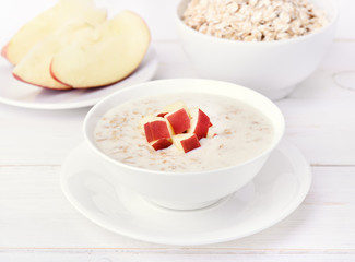 Oatmeal porridge with red apple slices