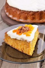 Piece of carrot pie with icing on glass plate