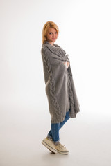 Woman in a sweater smiling on a white background