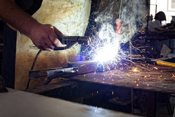 Man welding in workshop,shallow depth of filed