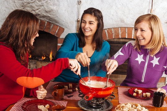 Friends having fondue dinner