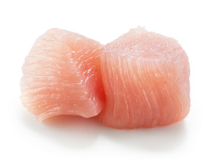 Raw chicken fillet. Small pieces of meat isolated on white.