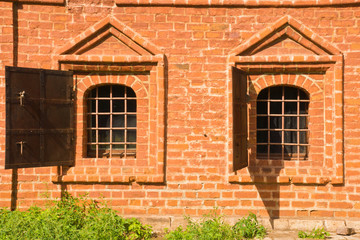 windows of old brick manor house in the park