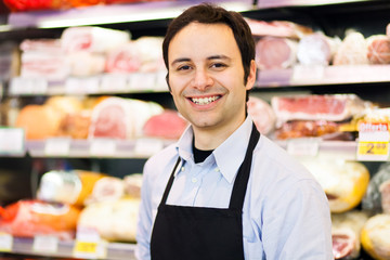 Smiling shopkeeper in a butchery