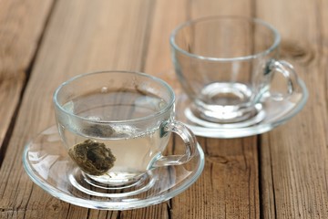 Pressed green puerh tea brewed in glass teacup