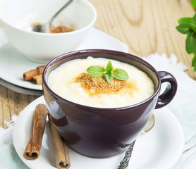 Rice Pudding with Cinnamon Powder and Mint Leaf