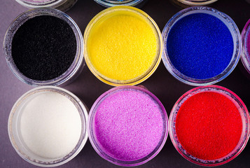 a lot of multicolored paint in jars for makeup artistry