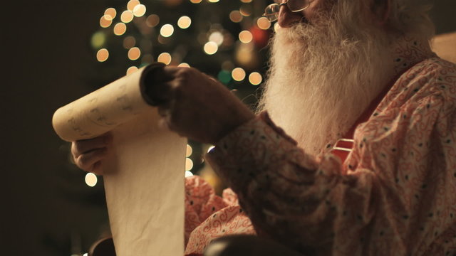 Santa Claus reading his list of naughty and nice