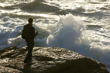 fishermen on the coast with big waves in Corunna Spain