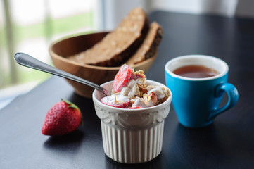 Breakfast with muesli, strawberry and yogurt