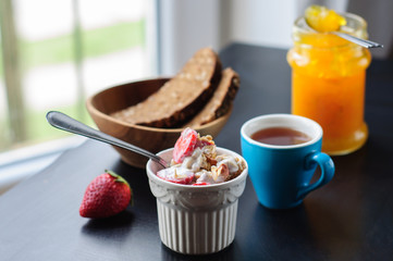 Breakfast with muesli, strawberry and yogurt