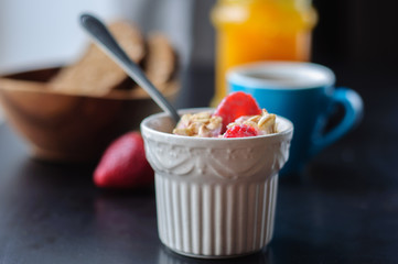 Breakfast with muesli, strawberry and yogurt