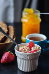 Breakfast with muesli, strawberry and yogurt