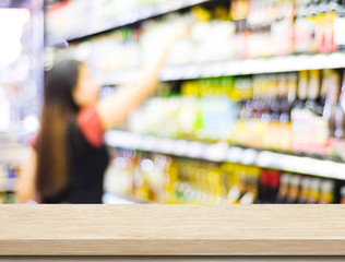 Empty table over blur supermarket with bokeh