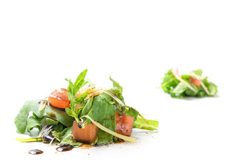 small heaps of rucola salad with tomatoes and  parmesan isolated