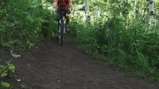 SLO MO MS PAN Man with artificial limb riding mountain bike on forest trail / American Fork Canyon, Utah, USA