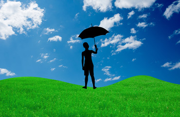silhouette of a boy with umbrella in summer