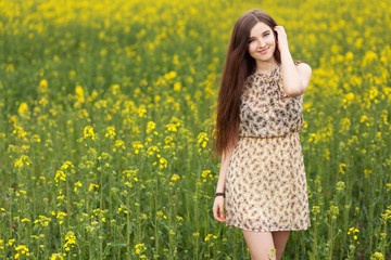Naklejka na ściany i meble Young beautiful woman in the fields
