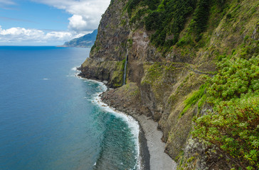 Steep northern shore of the island of Madeira, a waterfall.