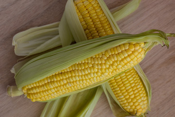 Corn cobs on wood background