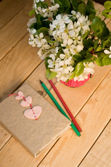 A bouquet of white spring flowers and old vintage notebook