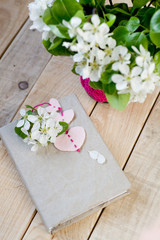 A bouquet of white spring flowers and old vintage notebook