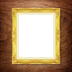 Antique gold frame on wooden wall ;. Empty picture frame on whit