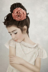 Portrait of little girl with rose in hair