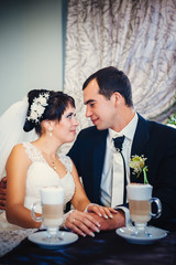 Love you honey.  Newly wed couple drinking cappuccino in cafe.